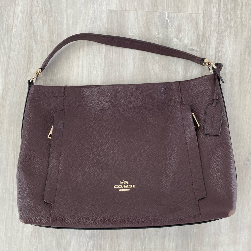 Gently used Coach shoulder bag with champagne hardware.